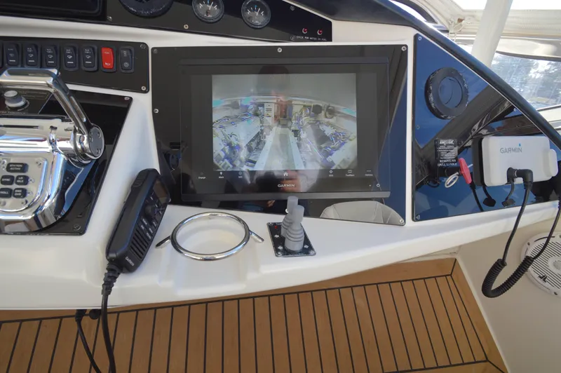 Slide: The Image of 2007 Marquis 59 yacht helm with Garmin navigation display and controls. - 23
