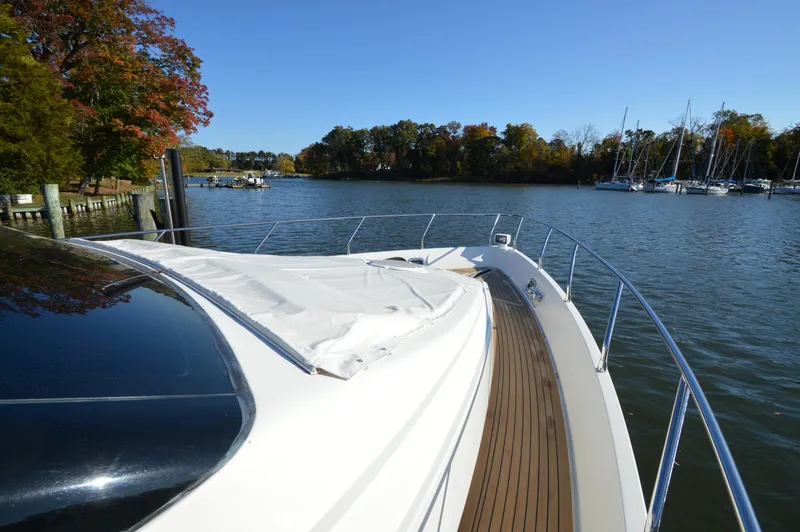 Slide: The Image of 2007 Marquis 59 yacht on serene lake with autumn trees and sailboats. - 26