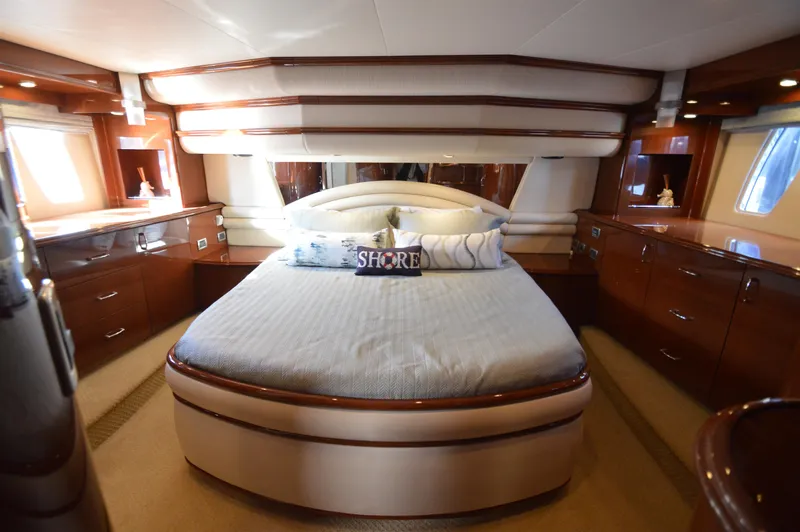 Slide: The Image of Luxurious 2007 Marquis 59 yacht bedroom with elegant wood cabinetry and plush bedding. - 3