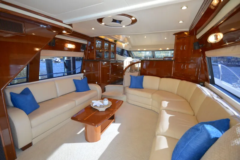 Slide: The Image of Luxurious 2007 Marquis 59 yacht interior with elegant seating and blue cushions. - 30