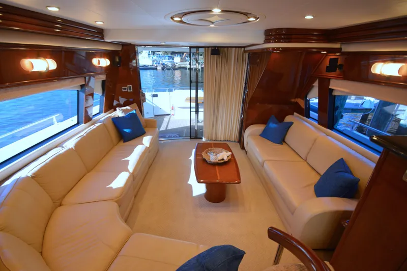 Slide: The Image of Luxurious 2007 Marquis 59 yacht interior with beige sofas and blue cushions. - 31