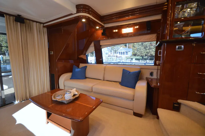 Slide: The Image of Luxurious 2007 Marquis 59 yacht interior with cream sofa and wooden accents. - 32