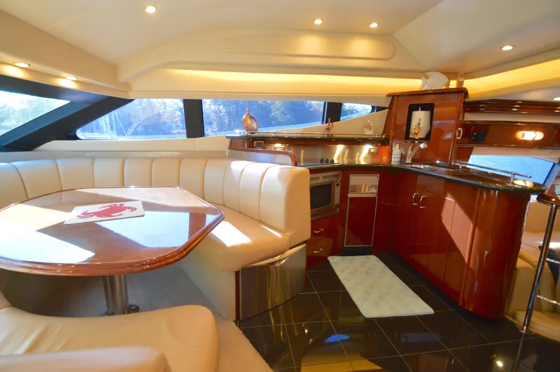 Slide: The Image of Luxurious 2007 Marquis 59 yacht interior with elegant dining and kitchen area. - 35