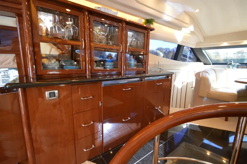 Slide: The Image of Luxurious interior of a 2007 Marquis 59 yacht with elegant wood cabinetry and seating. - 37