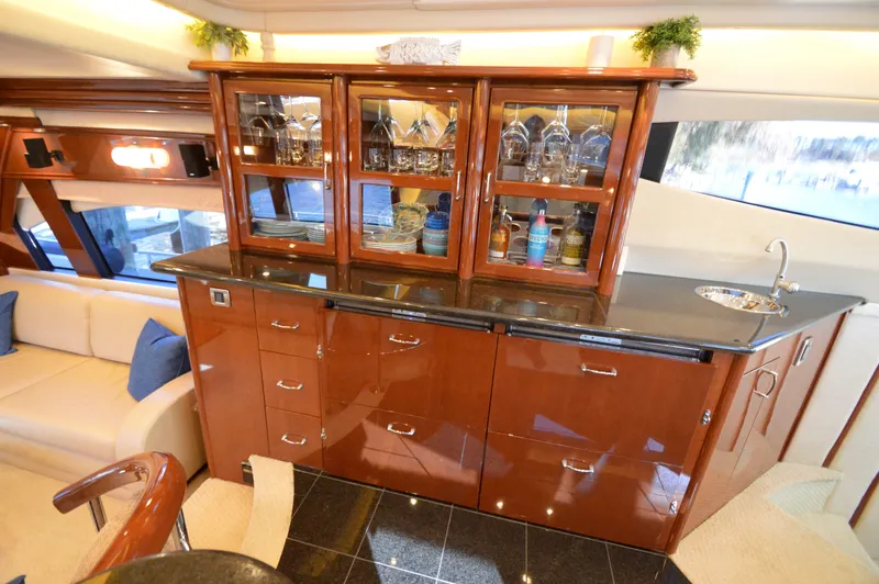 Slide: The Image of Luxurious interior of 2007 Marquis 59 yacht with elegant cabinetry and glassware display. - 38