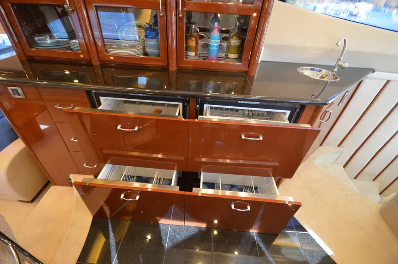 Slide: The Image of Luxurious 2007 Marquis 59 yacht kitchen with wooden cabinets and modern appliances. - 39