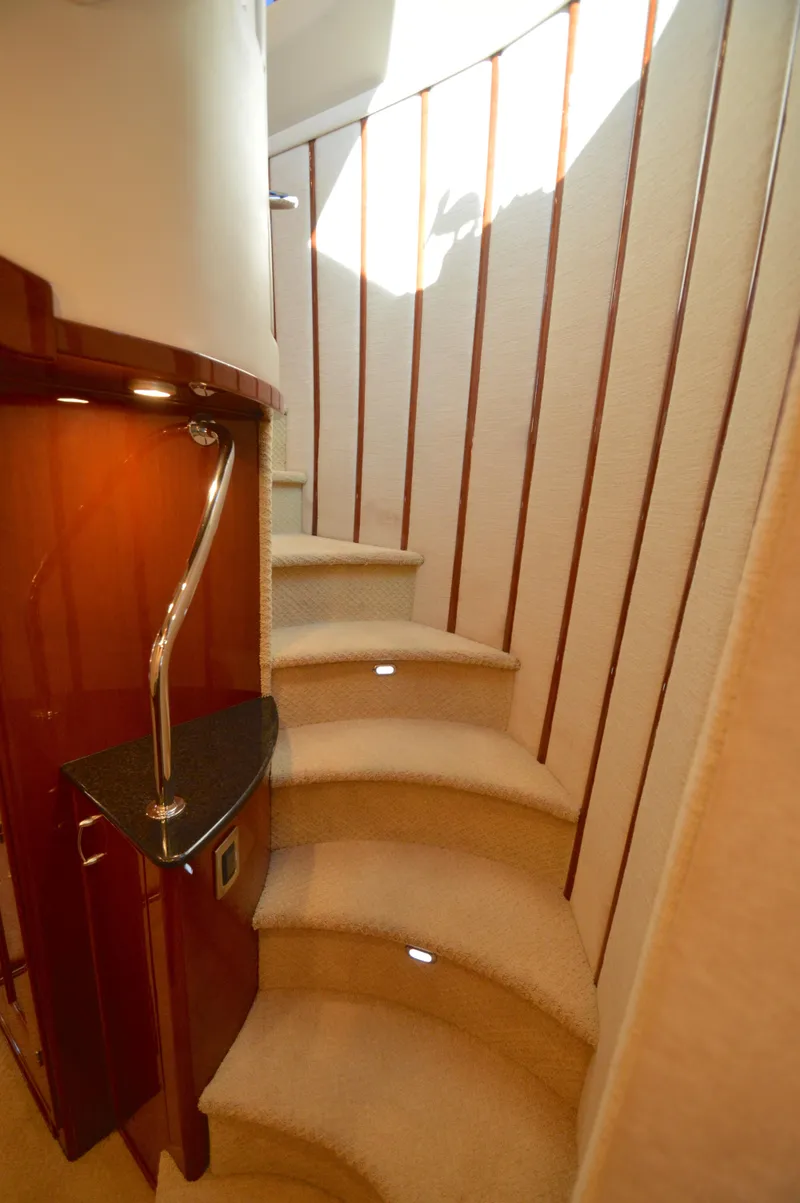 Slide: The Image of Luxurious 2007 Marquis 59 yacht interior with elegant curved staircase. - 40