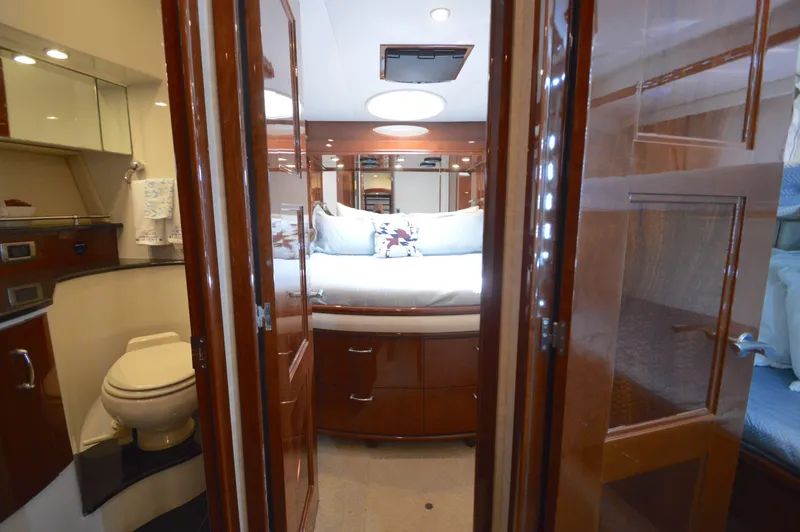 Slide: The Image of Luxurious 2007 Marquis 59 yacht interior with elegant wood finishes and cozy bedroom. - 43