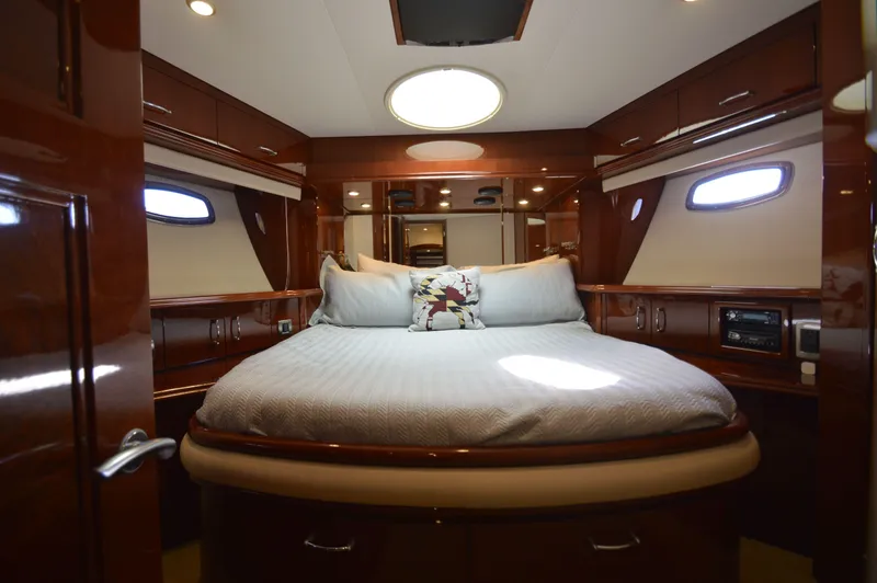 Slide: The Image of Luxurious 2007 Marquis 59 yacht bedroom with elegant wood finish and plush bedding. - 45