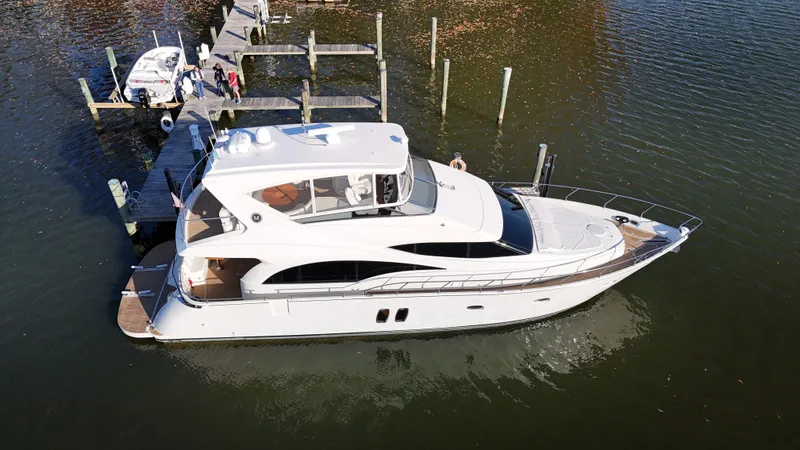 Slide: The Image of 2007 Marquis 59 yacht docked on calm water, aerial view. - 5