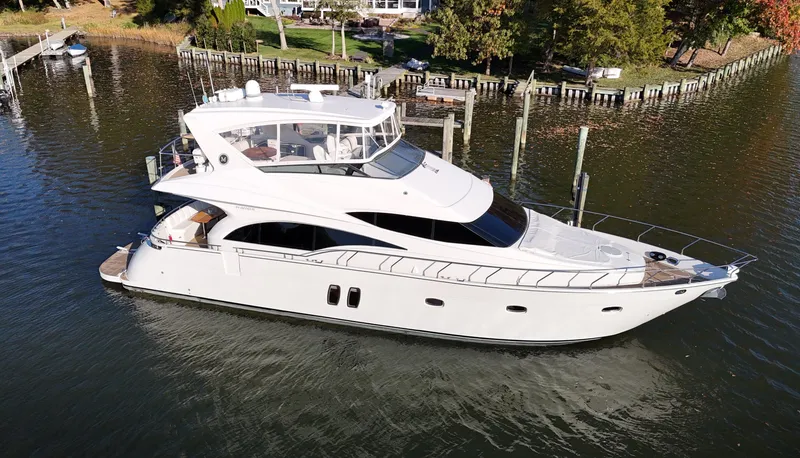 Slide: The Image of 2007 Marquis 59 yacht on calm water near a dock. - 6
