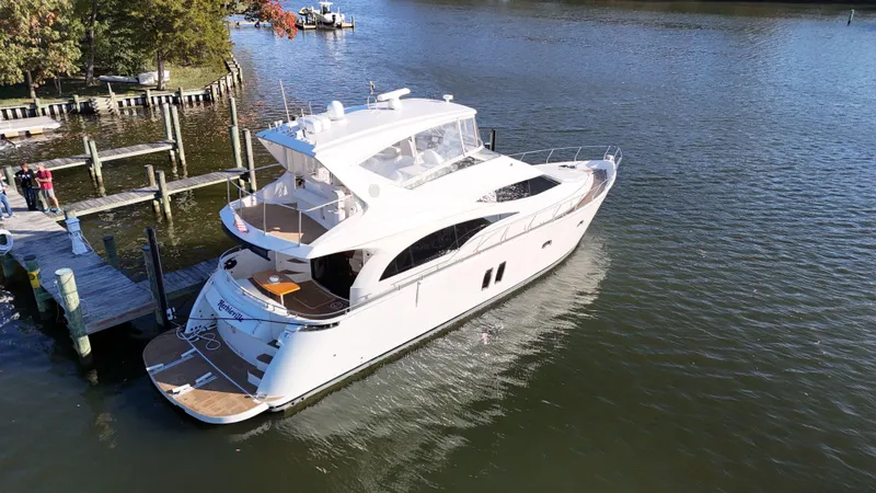 Slide: The Image of 2007 Marquis 59 yacht docked on a serene waterfront. - 7