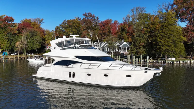 Slide: The Image of 2007 Marquis 59 yacht cruising on a scenic lake with autumn trees. - 8