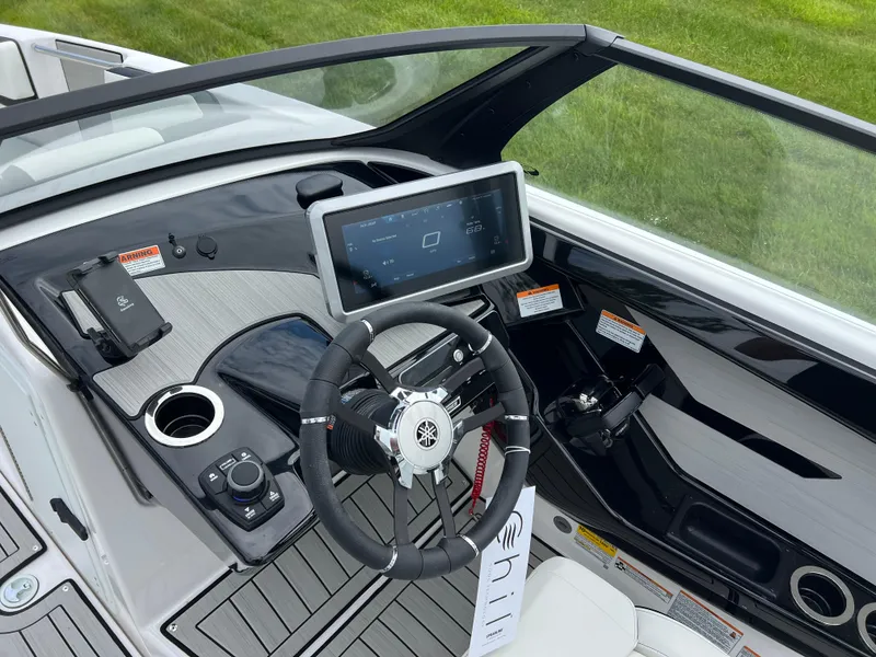 Slide: The Image of 2025 Yamaha Boats 222SE dashboard with touchscreen display and steering wheel, showcasing modern design. - 12