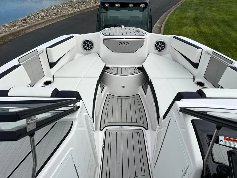 Slide: The Image of 2025 Yamaha Boats 222SE interior, featuring sleek white seating and modern design elements. - 15