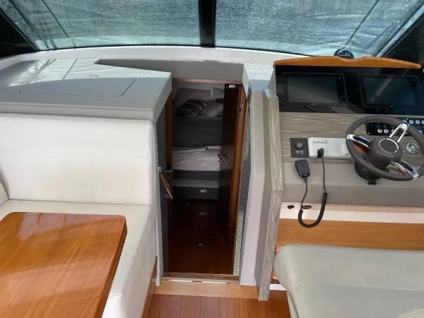 Slide: The Image of 2019 Tiara Sport 39 yacht interior with helm, seating, and cabin entrance. - 5