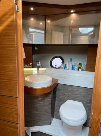 Slide: The Image of 2019 Tiara Sport 39 yacht bathroom with modern fixtures and porthole window. - 7