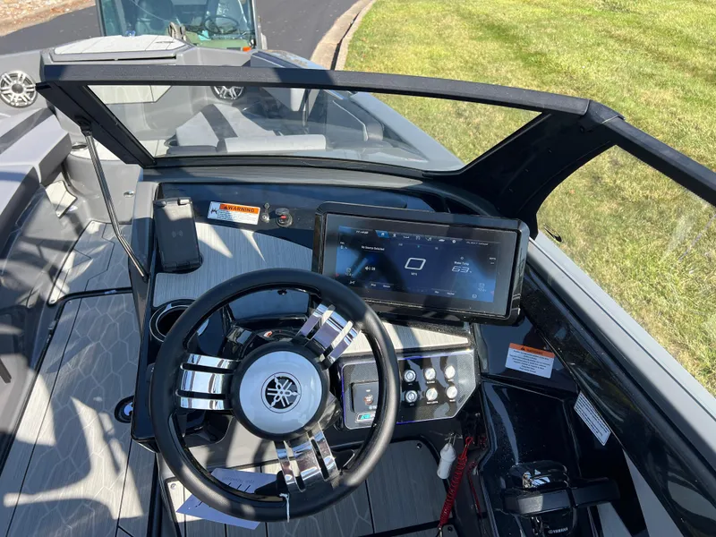 Slide: The Image of 2025 Yamaha Boats 222XD dashboard with steering wheel and touchscreen display. - 14