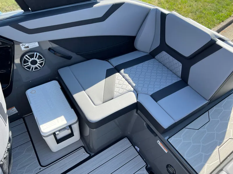 Slide: The Image of 2025 Yamaha Boats 222XD interior seating with modern design and speaker system. - 23