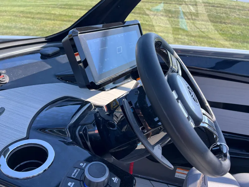 Slide: The Image of 2025 Yamaha Boats 222XD dashboard with steering wheel and touchscreen display. - 26