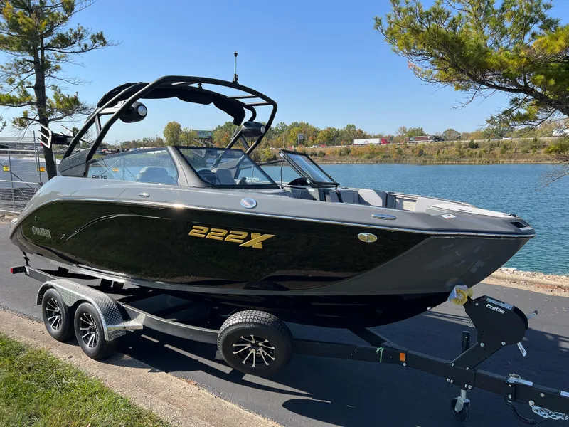 Slide: The Image of 2025 Yamaha Boats 222XD on trailer by a scenic lake. - 3
