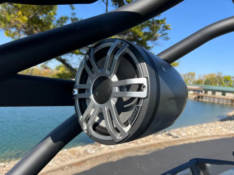 Slide: The Image of Close-up of a Yamaha Boats 222XD 2025 speaker, mounted on a boat near a lake. - 31