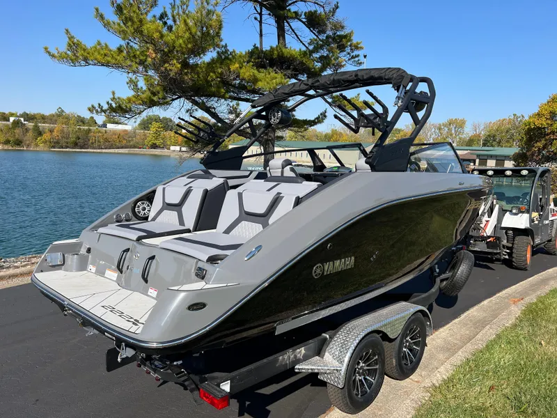 Slide: The Image of 2025 Yamaha Boats 222XD on trailer by a scenic lake. - 5