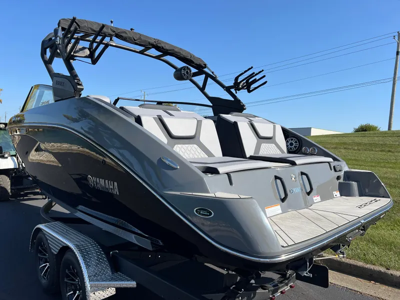 Slide: The Image of 2025 Yamaha Boats 222XD, sleek design, parked on trailer, sunny day. - 8