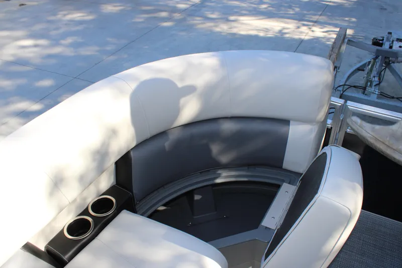 Slide: The Image of Starcraft LX 20 CB 2025 boat interior with curved seating and cup holders. - 11