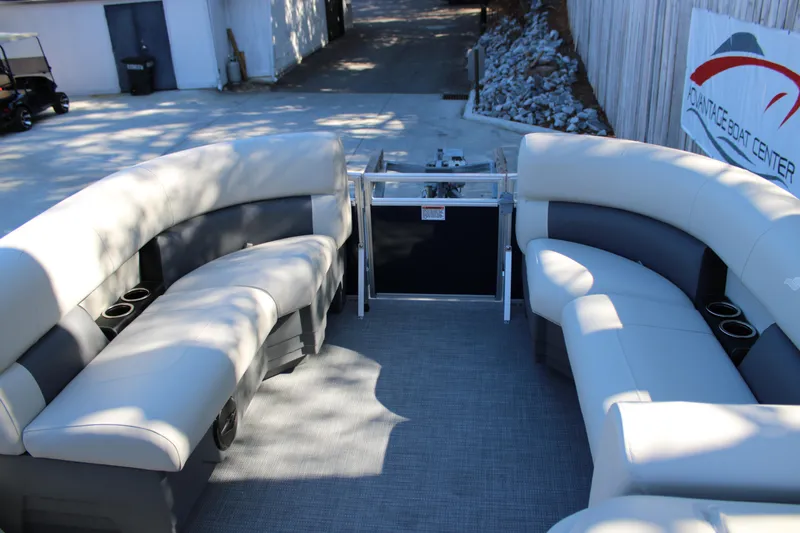 Slide: The Image of 2025 Starcraft LX 20 CB pontoon boat interior with plush seating and cup holders. - 13