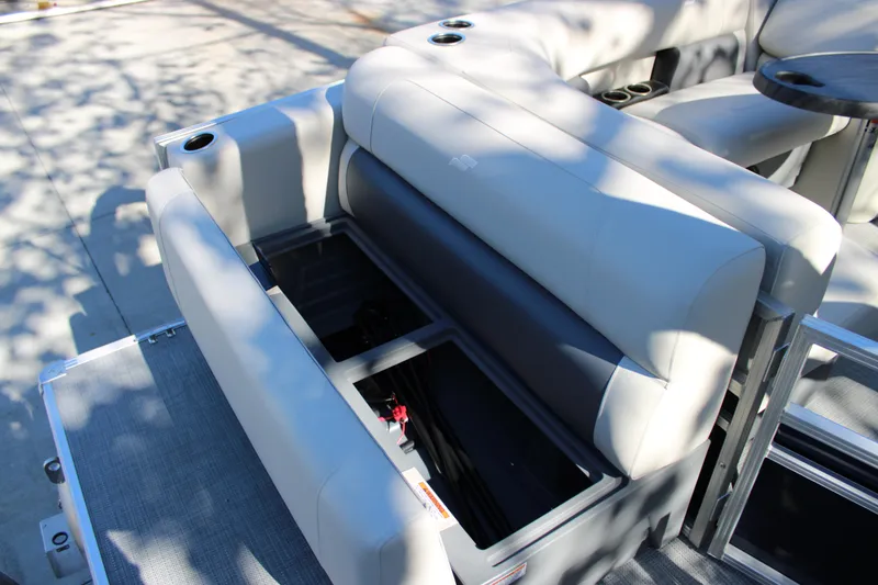 Slide: The Image of Starcraft LX 20 CB 2025 boat with open storage compartment and cushioned seating. - 4