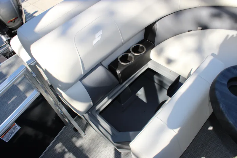 Slide: The Image of 2025 Starcraft LX 20 CB boat interior with cushioned seating and built-in cup holders. - 7