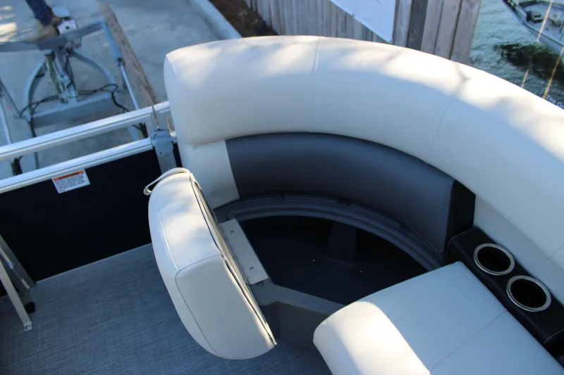Slide: The Image of 2025 Starcraft LX 20 CB boat interior with curved seating and cup holders. - 8