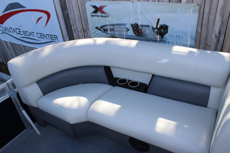Slide: The Image of Starcraft LX 20 CB 2025 boat interior with cushioned seating and cup holders. - 9