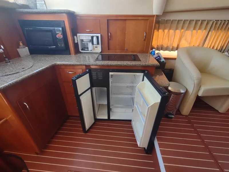 Slide: The Image of 2004 Carver 366 Motor Yacht kitchen with open fridge, microwave, and coffee maker. - 11