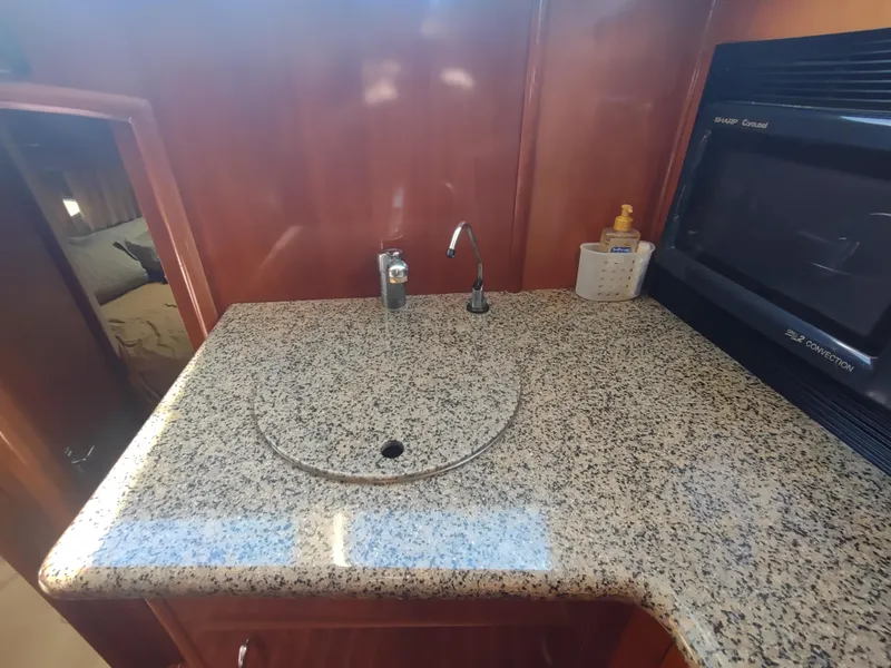 Slide: The Image of 2004 Carver 366 Motor Yacht kitchen with granite countertop and built-in appliances. - 12