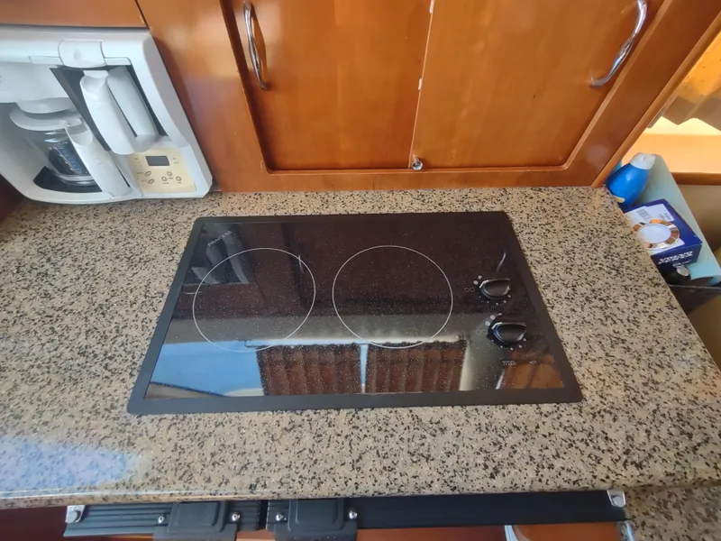 Slide: The Image of Granite countertop with electric stove in 2004 Carver 366 Motor Yacht kitchen. - 14