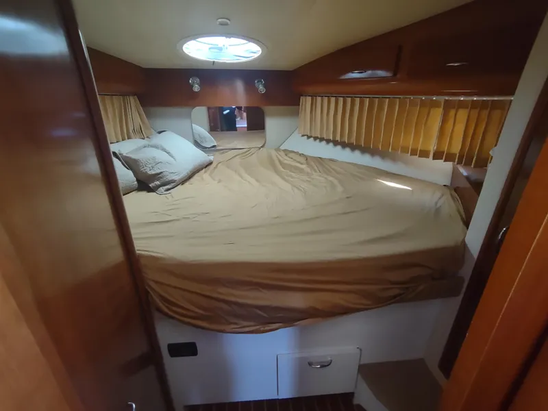 Slide: The Image of Interior cabin of 2004 Carver 366 Motor Yacht with cozy bed and porthole. - 17