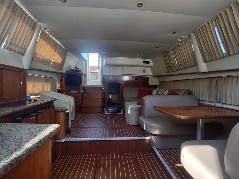 Slide: The Image of Interior of 2004 Carver 366 Motor Yacht with wood flooring and cozy seating area. - 24