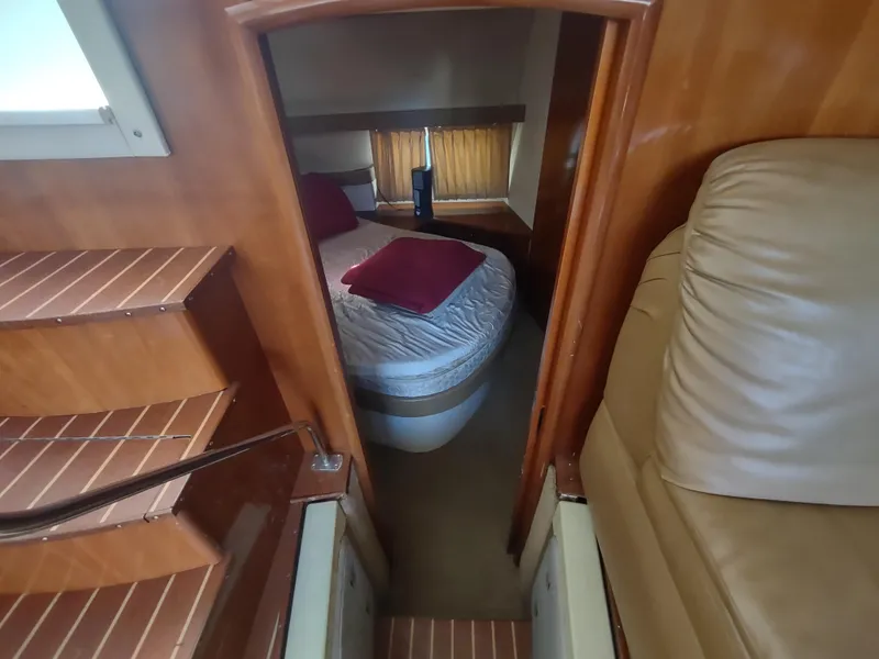 Slide: The Image of Interior of 2004 Carver 366 Motor Yacht with cozy bedroom and wooden finishes. - 25