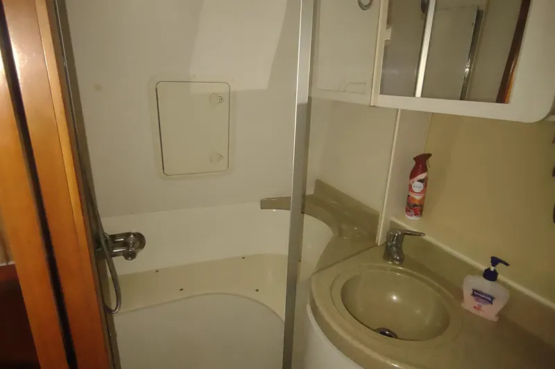 Slide: The Image of 2004 Carver 366 Motor Yacht bathroom with shower, sink, and toiletries. - 31