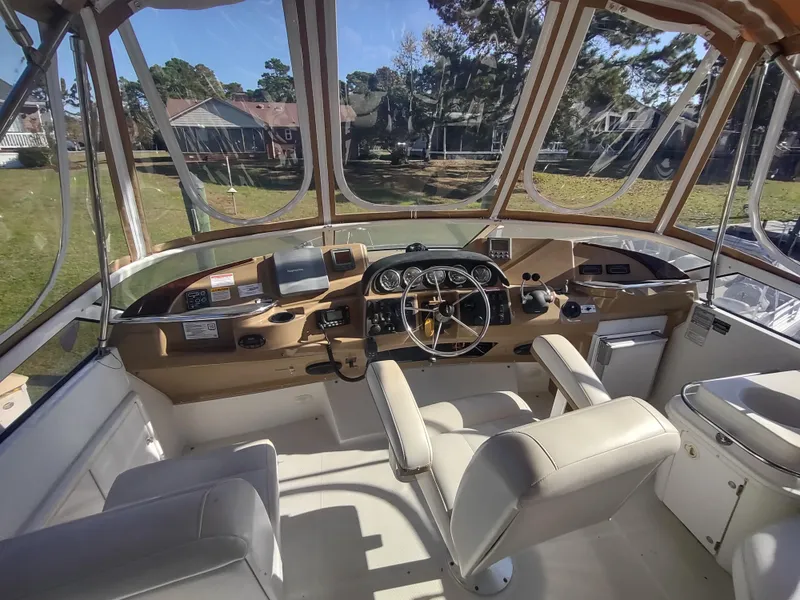 Slide: The Image of Interior view of 2004 Carver 366 Motor Yacht helm with steering wheel and controls. - 33