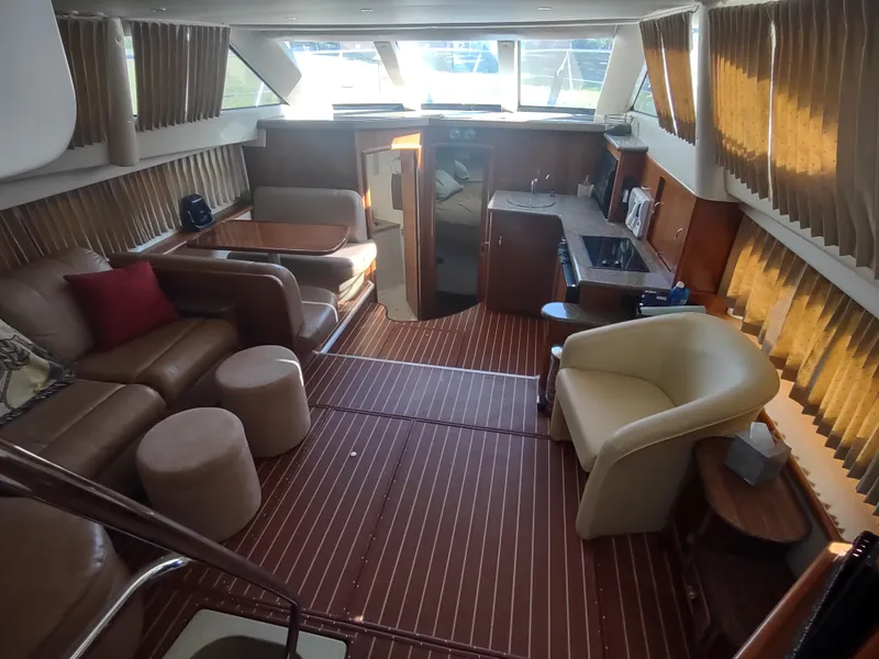 Slide: The Image of Luxurious interior of 2004 Carver 366 Motor Yacht with elegant seating and wood flooring. - 5