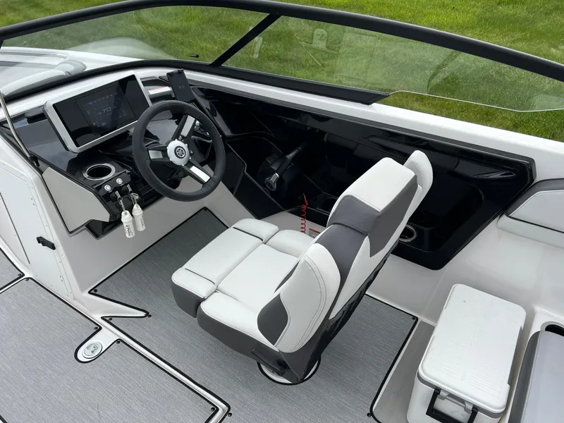 Slide: The Image of 2025 Yamaha Boats AR250 cockpit with modern steering and seating design. - 11
