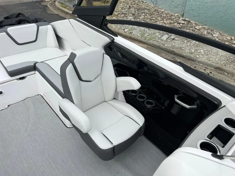 Slide: The Image of 2025 Yamaha Boats AR250 interior with white seating and modern dashboard design. - 23
