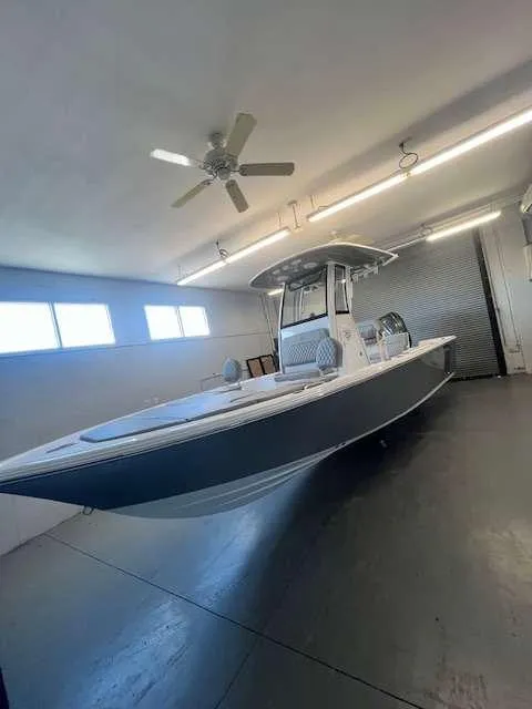 Slide: The Image of 2025 Sportsman 227 MASTERS boat in a well-lit garage. - 1