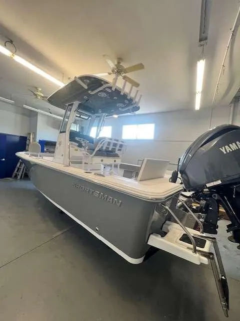 Slide: The Image of 2025 Sportsman 227 MASTERS boat in a garage with Yamaha outboard motor. - 11