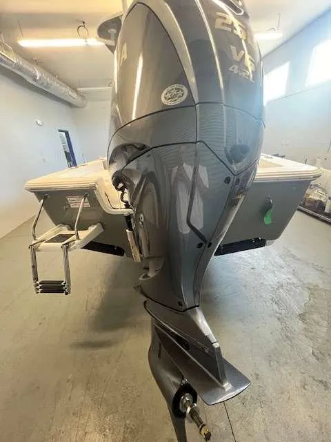 Slide: The Image of 2025 Sportsman 227 MASTERS boat with powerful outboard motor in a garage setting. - 12