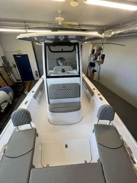 Slide: The Image of 2025 Sportsman 227 MASTERS boat interior in a garage setting. - 3