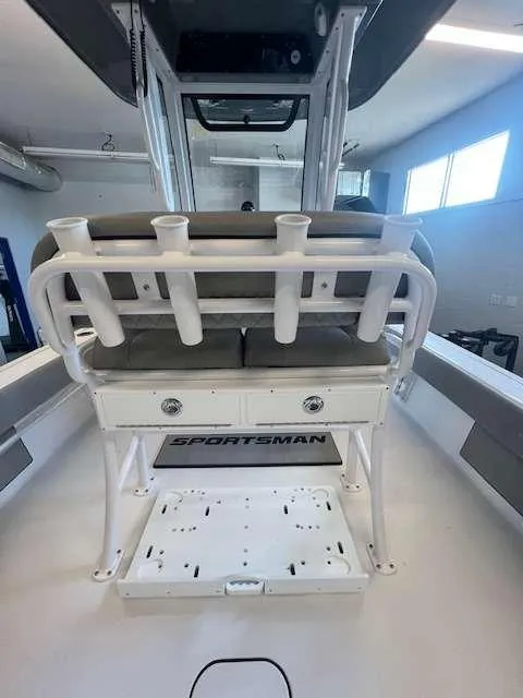 Slide: The Image of 2025 Sportsman 227 MASTERS boat interior with rod holders and seating. - 7